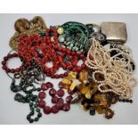 A large collection of jewellery, to include: red stone necklace, green jade bead necklace, two amber