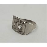 An Art Deco precious white metal and diamond ring, having rectangular face set pair of old-cut