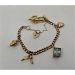 A 9ct. gold graduated curb link charm bracelet, suspending an 18ct. yellow and rose gold charm of