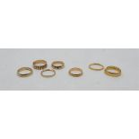 A collection of gold bands, to include: two 22ct. gold bands (6.2g, as found), four 9ct. gold