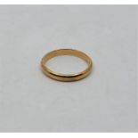 A precious yellow metal wedding band, (yellow metal assessed as 18ct. gold).(3.4g). Size: UK S