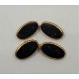 A pair of precious yellow metal and bloodstone cufflinks, each oval face bezel set flat cut