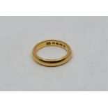 A 22ct. gold band, (5.6g). Size: UK L+