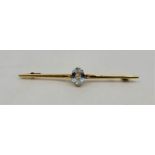 A 15ct. gold and aquamarine bar brooch, claw set oval mixed cut aquamarine, length 5.7cm (3.0g),