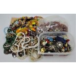 A large quantity of costume jewellery, to include: simulated pearls, amber necklace, brooches,