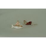 A porcelain art deco figure of a reclining lady Length 5" And another of a lady and a fish  Length