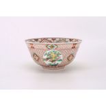 A Chinese porcelain palace bowl painted in colorful enamels, painted with four panels of dancing