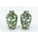 A pair of Chinese baluster vases painted with prunes on a green ground Ming mark on base Height 32cm