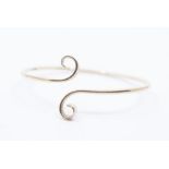 A 9ct gold torque slave bangle, round wire with scrolled terminal, internal diameter approx 8.5cm,