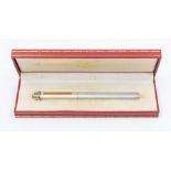 A Cartier Must de Cartier Vendome ballpoint pen in a silver metal with gilt. In original branded