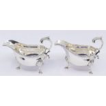 A pair of Georgian style large oval sauceboats, gardroon border on three shell and hoof feet, S-