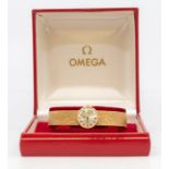 Omega- a ladies 9ct gold Omega wristwatch, comprising a round silvered dial, with applied gold
