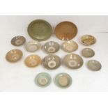 A group of fifteen Chinese and South East Asian celadon dishes, 15th/16th century, some incised with