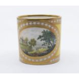 A French hard paste coffee can, c.1800, decorated with yellow ground and English landscape panel,