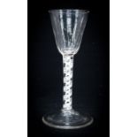 An 18th century opaque twist wine glass, the conical bowl, half fluted to the lower section, on a