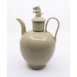 A Chinese green glazed ewer and cover, Song Dynasty, of globular form with an upright spout set on