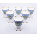 A set of six late 19th Century German Altwasser porcelain goblets, ogee shaped with gilt rims, the