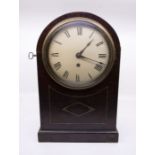 A Victorian single fusee round top mantel clock with 7" white round dial and cast bezel. Contained