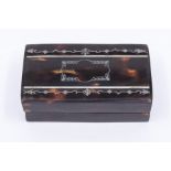An early 20th Century tortoiseshell stamp box, the cover inlaid with silver decoration, with