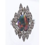 An Andrew Grima London opal and diamond platinum set ring, circa 1970's, comprising a central oval