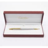 A Cartier 'Santos' ballpoint pen, in two tone metal.  In branded presentation box.  Condition: in