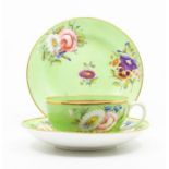An S&H Derby tea cup, saucer and side plate, decorated with flower groups on an apple green