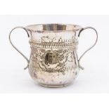 A George III silver two handled loving cup, waisted with flared rim, the body chased with flowers,