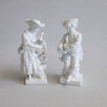 A small pair of white Meissen figures of grape pickers, she is picking grapes from a tree, and he is