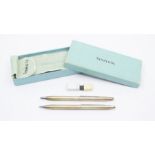 A Tiffany & Co gilt retractable purse ballpoint pen, along with a gilt retractable pencil, with