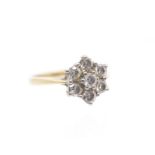 A diamond and 18ct gold cluster ring, comprising a claw set flower cluster of round brilliant cut