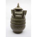 A Chinese Longquan celadon funerary jar and cover, Song dynasty, the rounded, heavily potted body,