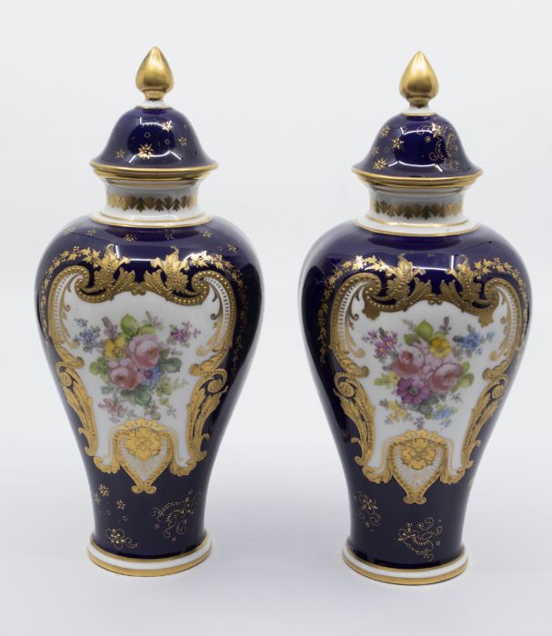 A pair of early 20th Century Royal Crown Derby vases and covers, cobalt blue grounds painted with