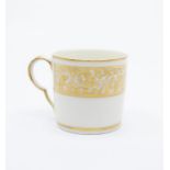 A Pinxton coffee can, pattern no.283, gilt foliate border, typical ear-shaped handle