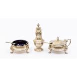 A Georgian style set of three silver condiments to include: salt, mustard and pepper pot, with