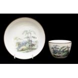 A Pinxton pattern 218 landscape decorated tea cup and saucer, polychrome landscape in the style of