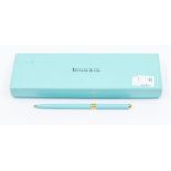 A Tiffany & Co compact purse ballpoint pen in Tiffany blue with gilt banding, along with