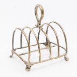 A William IV large silver five bar toast rack, loop handle on four scroll feet, hallmarked by Robert