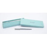 A Tiffany & Co. T-Clip silver metal twist ballpoint pen.  In original branded presentation box.