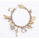 A 9ct gold charm bracelet with various 9ct gold and yellow metal charms including pistol, one