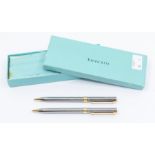 A Tiffany & Co. T-Clip chrome and gold plated twist ballpoint and mechanical pencil set.  In
