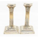 A pair of early 20th Century American silver Corinthian column candlesticks, engraved with