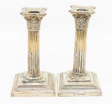 A pair of early 20th Century American silver Corinthian column candlesticks, engraved with