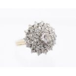 A diamond and 18ct gold bomb cluster ring, comprising a central set round brilliant cut diamond