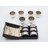 A matched set of six Art Deco silver egg cups, plain bodies, hallmarked by A C Bloxham Co.,