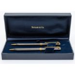 A Tiffany & Co. T-Clip chrome and gold plated twist ballpoint and mechanical pencil set.  In