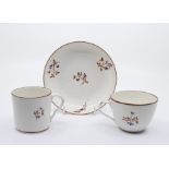 A Pinxton trio decorated in pattern no.1 red spring, comprising tea cup and saucer and coffee can,