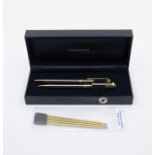 A Tiffany & Co. T-Clip chrome and gold plated twist ballpoint and mechanical pencil set, along