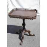 A George III style mahogany canted rectangular tilt top tripod table, lattice pierced gallery,