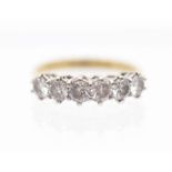 A six stone diamond  and 18ct gold ring, comprising claw set round brilliant cut diamonds, total