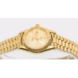 A ladies Geneve 14ct gold wristwatch, quartz movement, round gold tone dial with applied baton